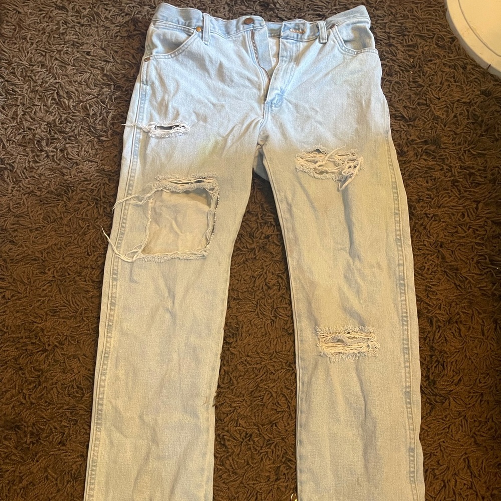 Cowboy cut distressed wranglers